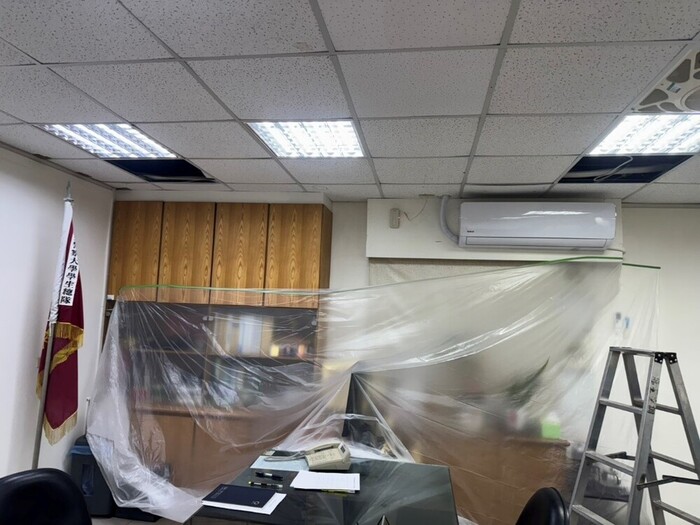 Contractor using dust bags during AC replacement to maintain a clean environment.